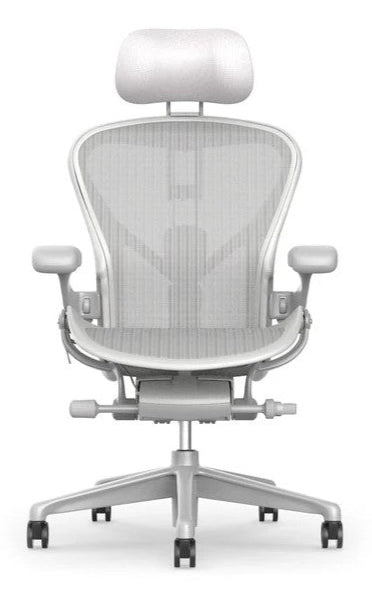 Front view of the Refurne Herman Miller Aeron Headrest by Atlas – Cushion Edition (Mineral), a modern office chair headrest with ergonomic support, mesh backrest, adjustable armrests, cushion headrest, and five-wheel base in light gray.