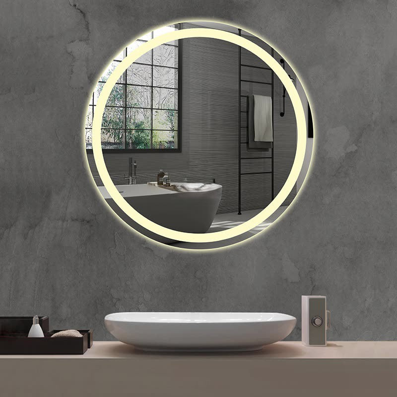 A modern bathroom showcases the Refurne Smart LED Bathroom Mirror – Round (frameless, defogging, adjustable lighting) on a gray wall, reflecting a bathtub and window. Below is a white vessel sink with accessories on the counter.