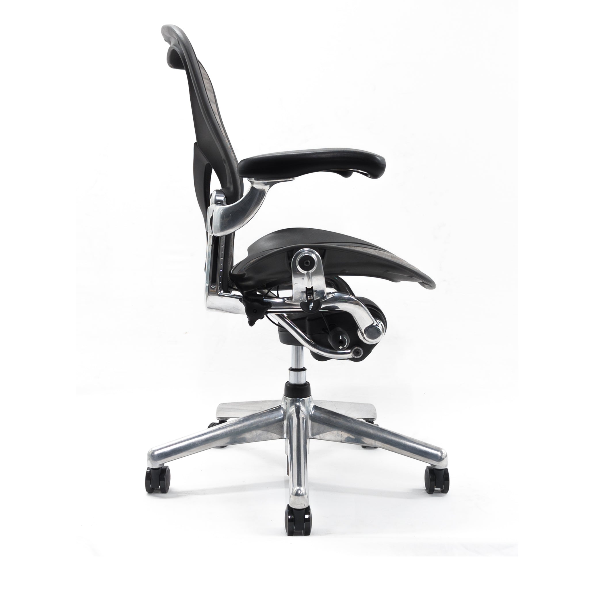 The Refurne Herman Miller Aeron Posturefit Chrome Office Chair - Size B - FULLY LOADED features a black seat and backrest, adjustable armrests, chrome base with five wheels, and Posturefit support, shown in a side view against a white background.