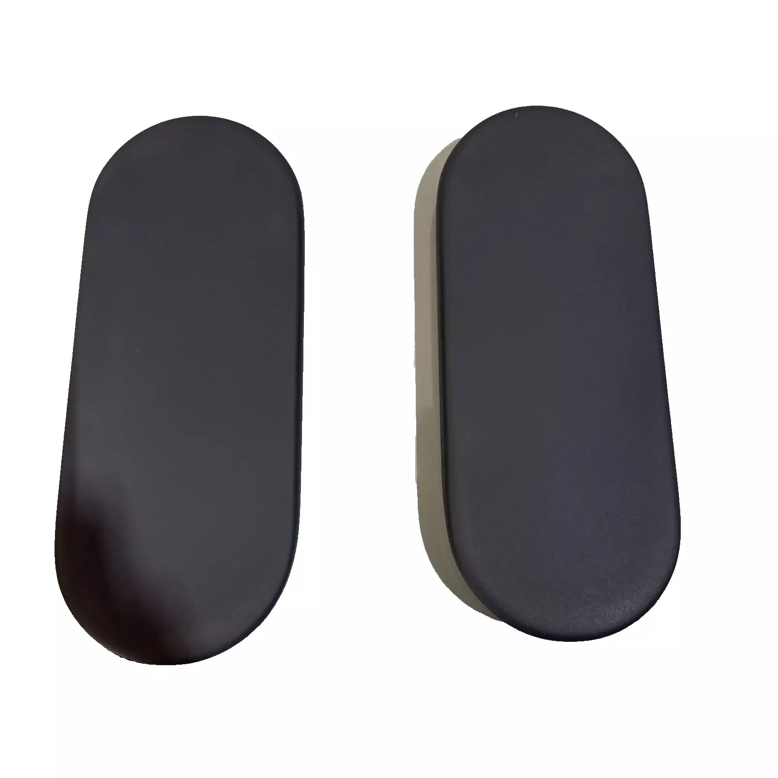 A pair of black, oval-shaped Herman Miller Sayl 2 - 4D armpads by Refurne with smooth surfaces are placed side by side on a white background, one casting a slight shadow—an ideal sustainable upgrade for your chair.
