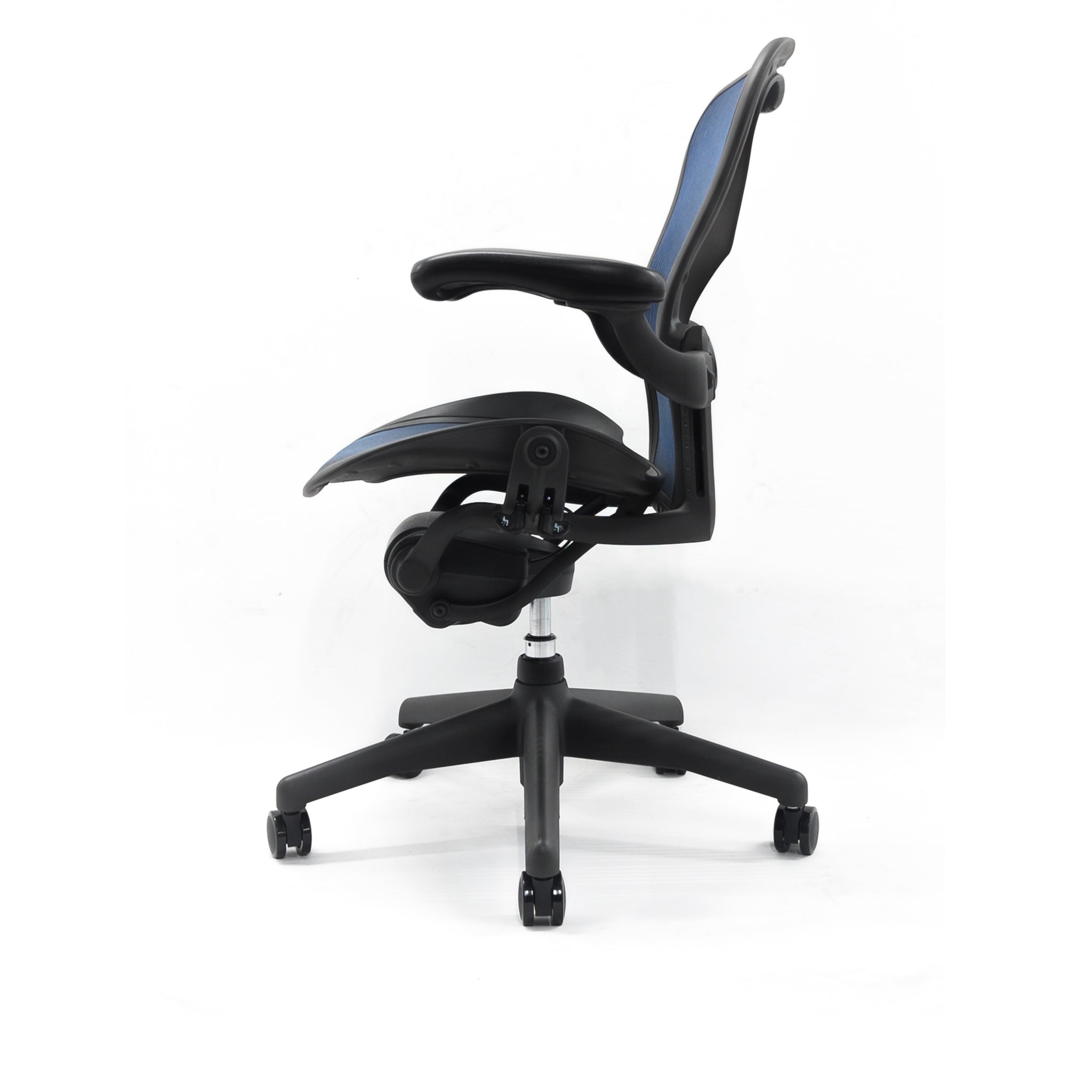 The Refurne Herman Miller Aeron Chair Size B, Fully Loaded with Posturefit Support and blue mesh, features adjustable armrests and a curved ergonomic backrest, shown from the side against a plain white background.