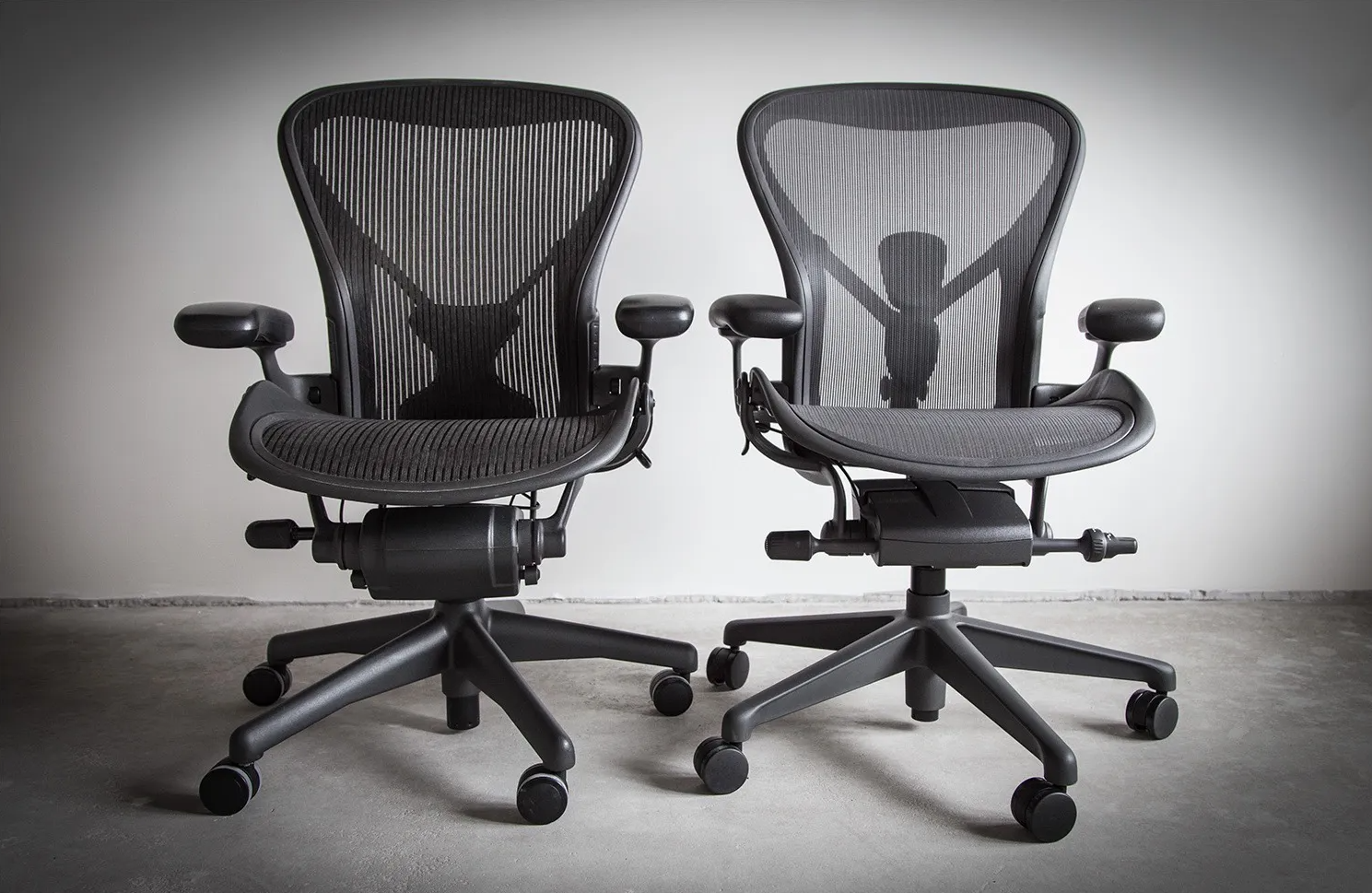 <img src="aeron-classic-vs-remastered.jpg" alt="Herman Miller Aeron Classic and Remastered chairs side by side">