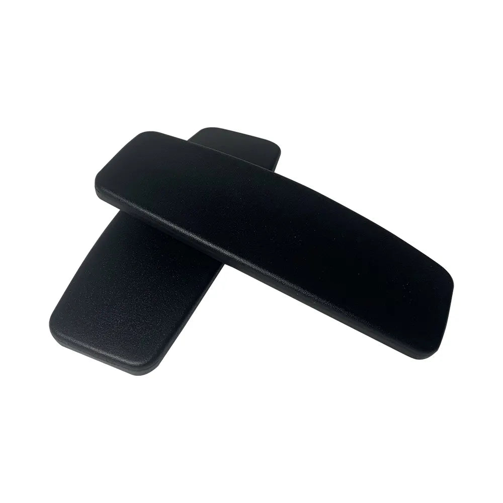 A pair of Refurne Steelcase Leap V2 Replacement Arm Pads in black are stacked on a white background, perfect for upgrading your chair’s ergonomics or replacing old armrests.