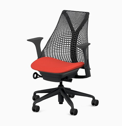 A modern black office chair with a mesh backrest, red cushioned seat, adjustable armrests fitted with Refurne Herman Miller Sayl Chair Replacement Armpads in black vinyl foam, and a five-wheel black base.